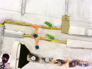 A detail view of the previous collage, showing mostly the eyes, some of the pipes, and one of the uniformed men.