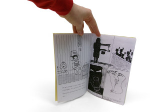 Another detail of the previous zine. This photograph shows two pages of its interior, with indistinct text and drawings featured.