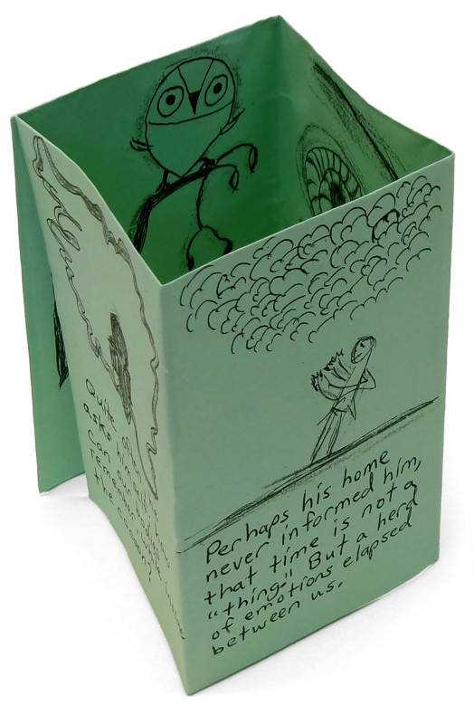 The previous zine, seen from another angle. This view shows a middle page. It has an indistinct drawing and indistinct text.