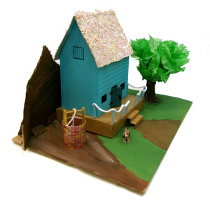 A side view of the previous sculpture. In this view, a small window painted onto the second story of the house is revealed.