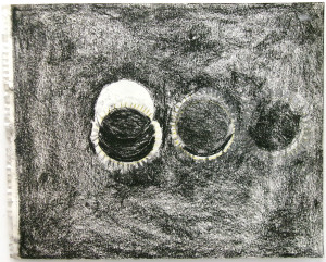 An image of three spherical shapes against a negative space. The shapes look like representations of an eclipse: the leftmost shape is a central white circle and a black circle offset below it. The black circle has small rays. The middle circle is entirely black with rays. The rightmost circle is all black, smaller, and has much less defined rays.